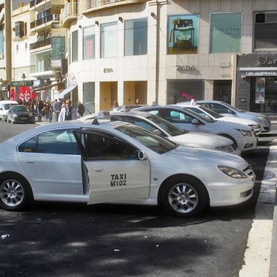 White taxis parked on the street