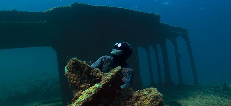 Freediver exploring a shipwreck while freediving in Malta 