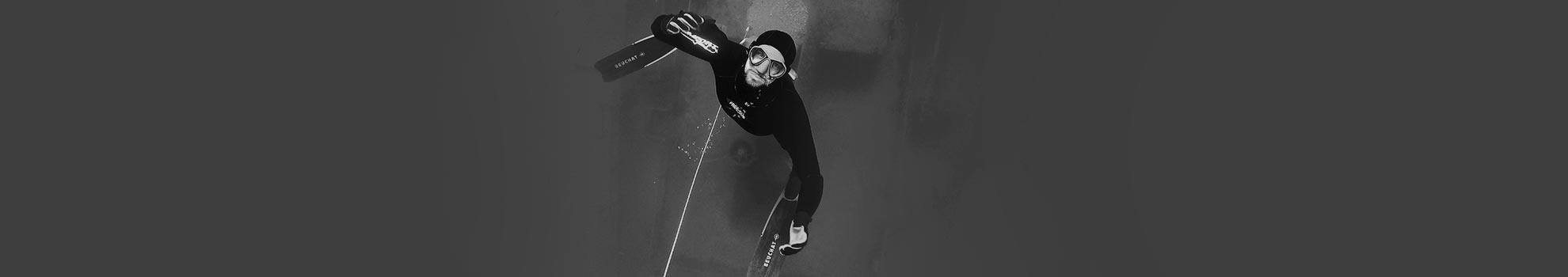 Freediver holding his breath while inside a shipwreck cabin