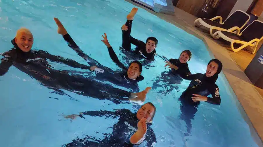 Group of freedivers in a pool in Gozo celebrating the end of their static apnea course water session